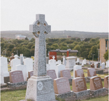 cross headstone in cemetery